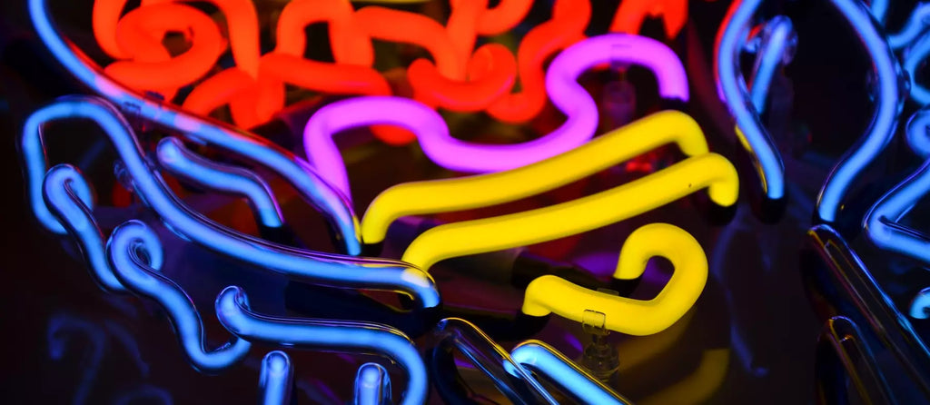 close-up shot of colourful glass neon tubes in blue, red, pink and yellow