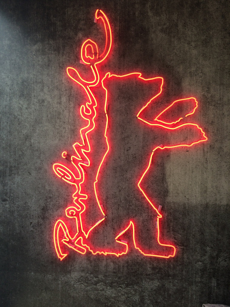 Berlinale logo as red neon sign on black wall 2016