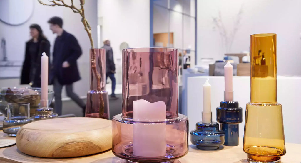 close-up shot of decorative tableware at ambiente frankfurt with visitors passing in the background